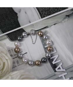 Détail de perles de couleurs mixtes avec un fermoir magnétique en strass et une chaîne