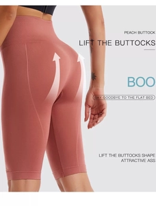 Close-up of peach high-waisted seamless biker shorts showing butt lifting knit detail
