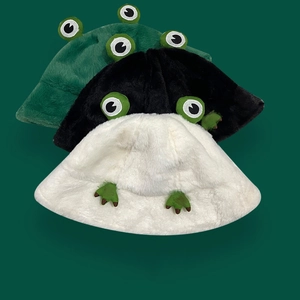 Three plush frog bucket hats in green black and white featuring soft faux fur and cute eyes