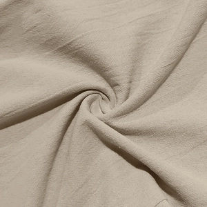 Macro shot of breathable beige cotton linen fabric showing detailed weave texture