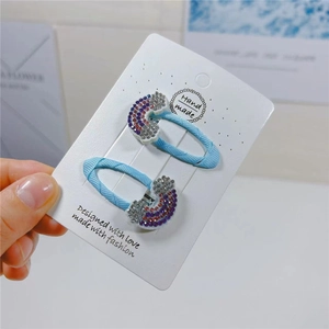 Sparkling blue rhinestone rainbow hair clips for kids on a handmade card set