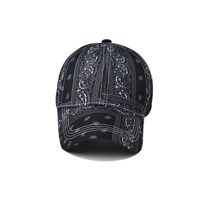 Classic black baseball cap featuring intricate white paisley patterns and cotton canvas