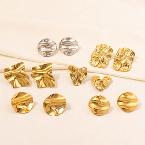 Macro shot of 18k gold plated 304 stainless steel earrings with irregular hammered texture