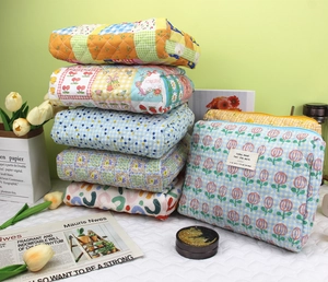 Detailed display of colorful quilted cotton toiletry bags in various floral patterns