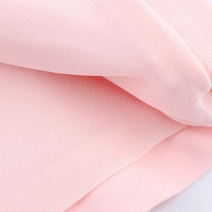 Detail shot of soft pink halter top fabric featuring a delicate diagonal twill weave texture
