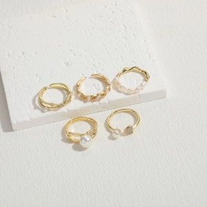 Detail of five-piece gold plated ring set featuring freshwater pearls and zircon stones