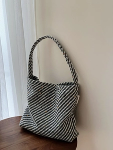 Dettaglio della borsa in tessuto bianco e nero con punti colorati ed etichetta in stoffa
