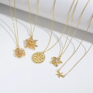 Set of five gold star and flower pendant necklaces with polished metal finish