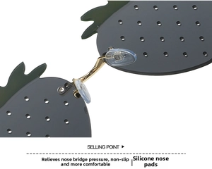 Detail of pineapple-shaped sunglasses featuring green leaves and soft silicone nose pads