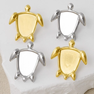 Detailed macro view of turtle shaped DIY jewelry bases in polished gold and silver finishes