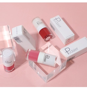 Three Pudaier matte liquid lipstick tubes in red and pink shades with packaging boxes