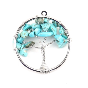 Detailed view of handmade silver wire wrapped tree of life pendant with turquoise stones