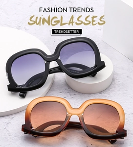 Detailed view of oversized square sunglasses with gradient lenses and frame size markings