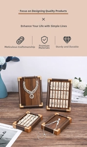 Detail of walnut wood jewelry display set with luxury gold metal corner accents