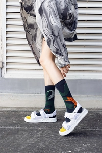 Detail of white platform sport sandals with yellow footbed and adjustable velcro straps