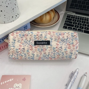 Detailed macro view of vintage floral corduroy pencil case and soft fabric texture