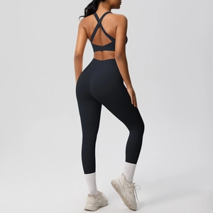 Back view of black yoga set featuring a cross-strap sports bra and high-waisted leggings