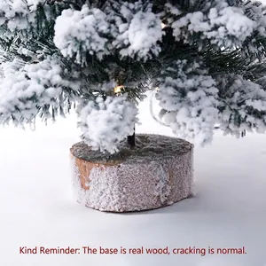 Mini flocked Christmas tree with realistic snow, LED lights, and natural wooden base