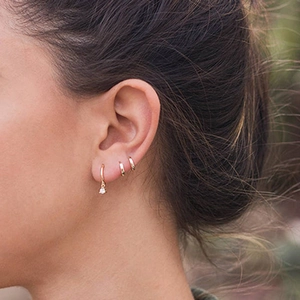 S925 silver needle gold hoop earrings with clear zircon charms worn by a model