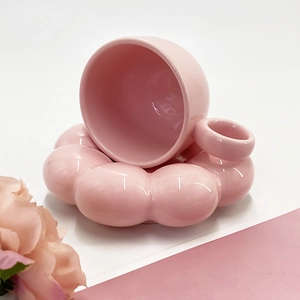 Detailed view of pink sunflower ceramic coffee cup and saucer with cloud edge design
