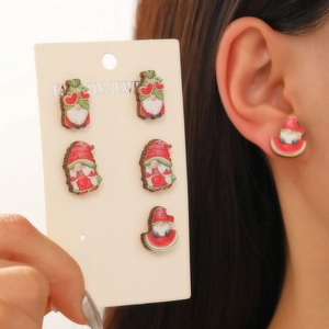 Detail of cute gnome stud earrings set with pink hearts and watermelon patterns