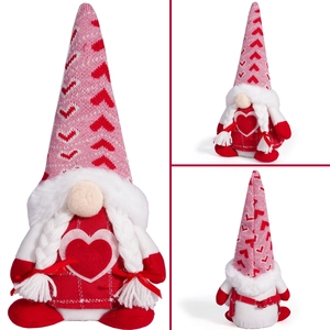 Detail view of pink knitted gnome with red hearts and white braids for Valentine's decoration