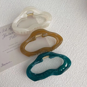 Set of three irregular matte hair claws in cream, brown, and dark green colors
