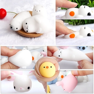 Close-up of soft TPR animal squishies being squeezed to show high elasticity and texture