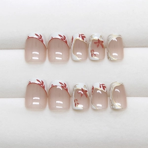 Press-on nails with cream base, white French tips, gold lines and red flower patterns