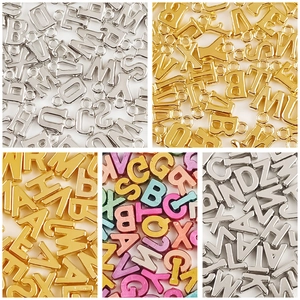 Assorted DIY acrylic macaron alphabet beads and metal letter charms for jewelry making
