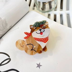 Detail of Shiba Inu acrylic hair claw clip with festive Christmas hat and red scarf