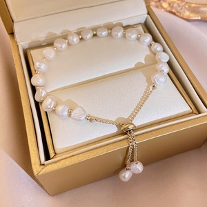 Close-up of Baroque freshwater pearl bracelet with adjustable gold sliding clasp in a gift box