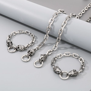 Detailed shot of stainless steel rectangular link chains with skull and lion head clasps