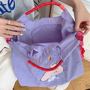 Detail of cute elephant embroidery on purple Oxford fabric tote bag with spacious interior