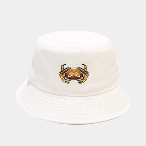 Close-up of white cotton bucket hat featuring a detailed orange crab embroidery design