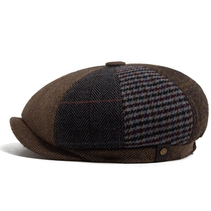 Retro patchwork wool newsboy cap with herringbone and plaid patterns on white background