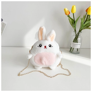 Detail of soft white plush rabbit bag featuring pink ears and a gold metal chain strap