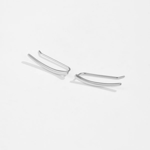 Macro shot of silver wheat ear stud earrings with cubic zirconia in a curved design