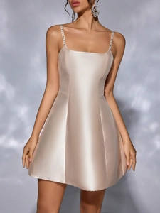 Champagne satin A-line dress with rhinestone spaghetti straps and a glossy finish