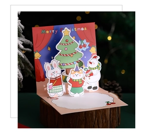 Pop-up Christmas card featuring cartoon animals and snowman on a wooden base