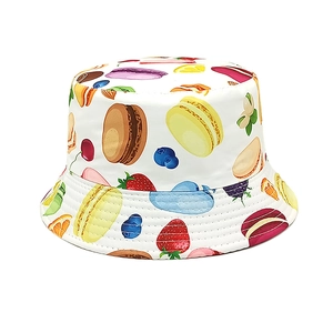 Detailed view of white cotton sun hat with colorful macaron and berry fruit patterns