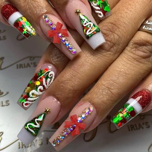 Christmas press-on nails with red glitter, green trees, and candy cane rhinestone designs