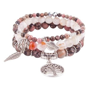 Detailed set of bohemian beaded bracelets featuring tree of life and leaf silver charms