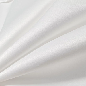 Macro shot of high-quality white silk fabric texture and smooth satin folds on short trench coat