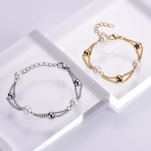 Detail of double-layer chain bracelet with freshwater pearls and polished metal beads
