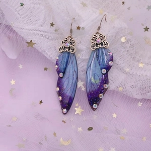Detailed close-up of gradient purple butterfly wings with crystals and silver hooks