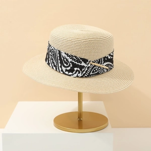 Classic beige straw boater hat with a paisley fabric band and gold metal buckle detail