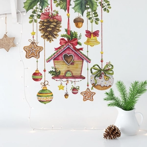 Close-up of watercolor Christmas wall stickers with birdhouse and bells on white wall