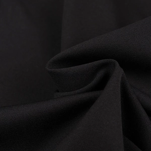 Close-up of premium black knitted fabric texture showing fine weave and soft matte finish