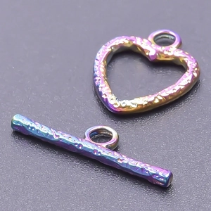 Macro view of rainbow plated stainless steel heart OT toggle clasp with textured finish